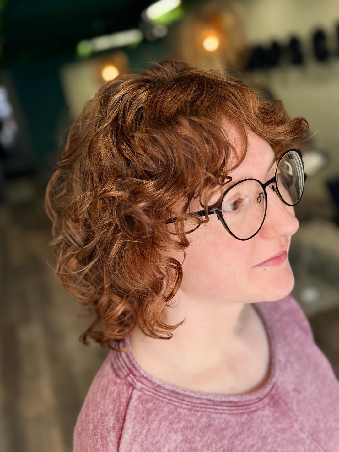 after image of a curly hair makeover with alyers around the face on mid length hair